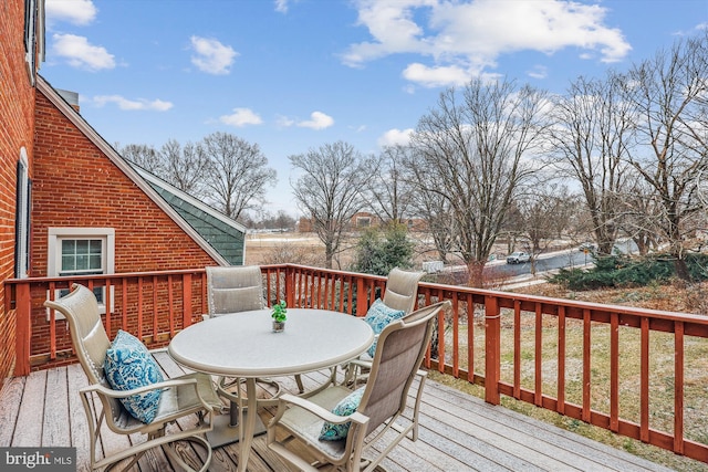 wooden deck featuring outdoor dining space