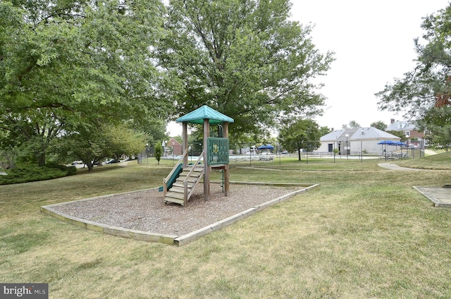 community playground with a yard and fence