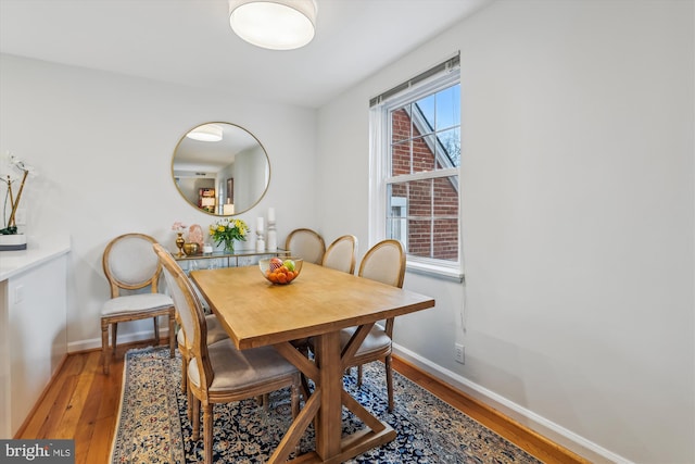 dining room featuring baseboards and light wood-style floors