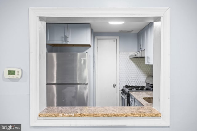 7153 Donnell Pl Unit A, District Heights, MD 20747 - kitchen featuring appliances with stainless steel finishes, under cabinet range hood, backsplash, and light stone counters