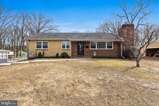 ranch-style home with a front lawn