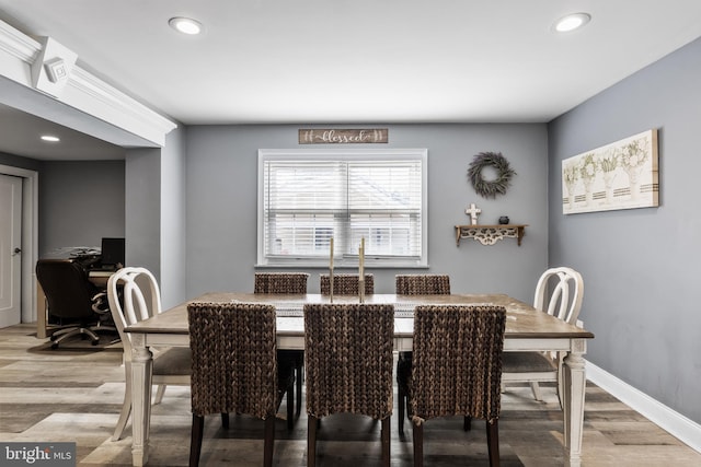 dining space featuring wood-type flooring