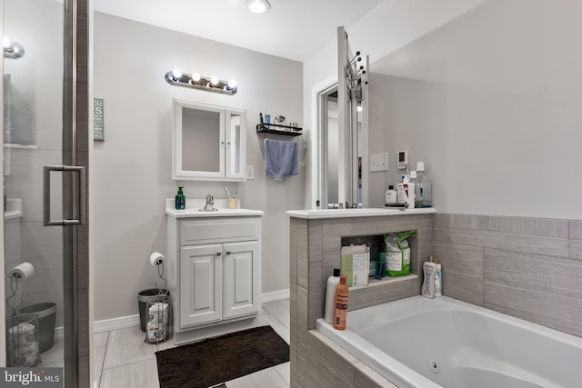 bathroom with vanity and shower with separate bathtub