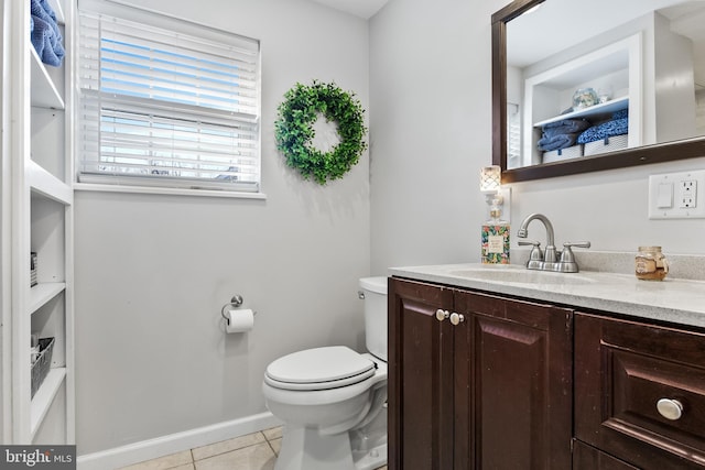 bathroom with vanity, toilet, and tile patterned flooring