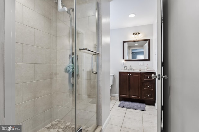 bathroom with vanity, tile patterned floors, toilet, and walk in shower