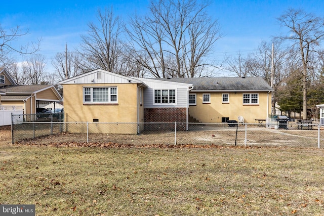 rear view of property with a lawn and a carport