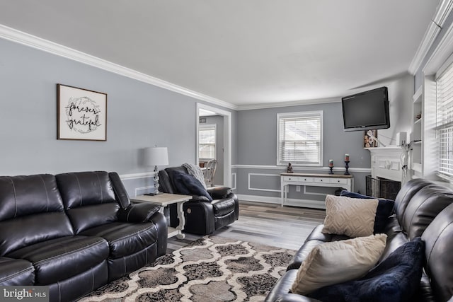 living room featuring light hardwood / wood-style flooring and ornamental molding