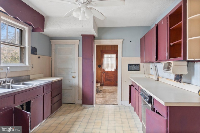 kitchen with dishwasher, ceiling fan, sink, and a textured ceiling