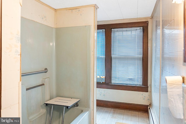 bathroom with a tub and baseboard heating