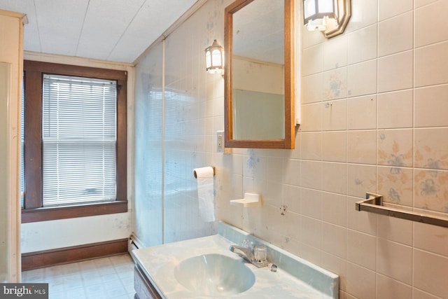 bathroom with tile walls and vanity