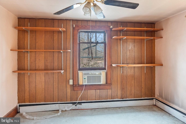 spare room with cooling unit, wooden walls, ceiling fan, and baseboard heating