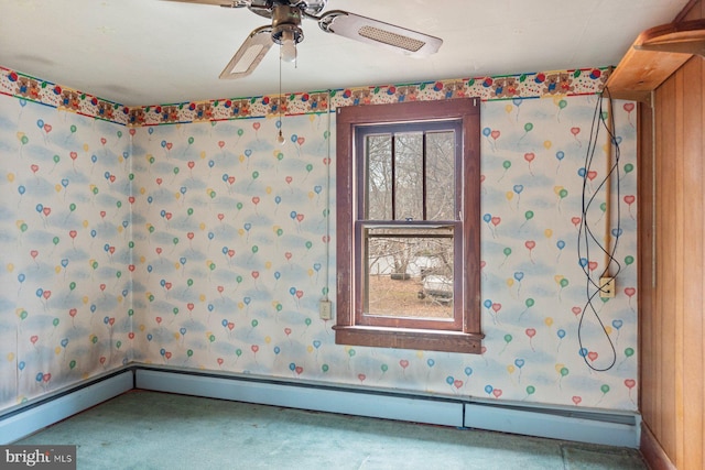 carpeted empty room featuring a baseboard radiator and ceiling fan