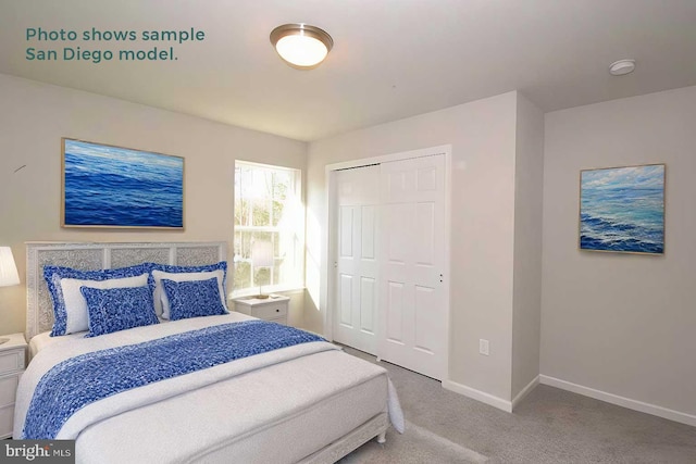 carpeted bedroom with baseboards and a closet