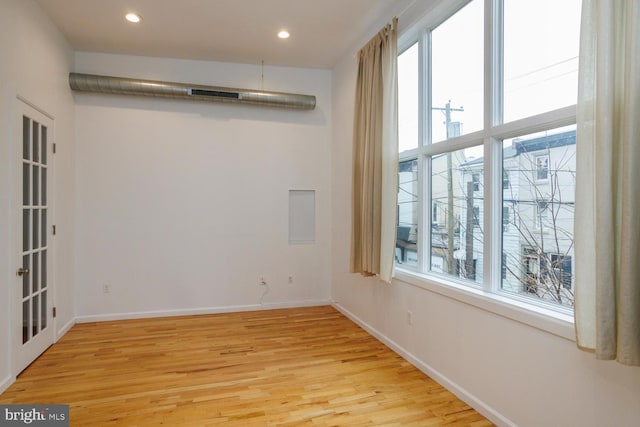 spare room with light hardwood / wood-style floors