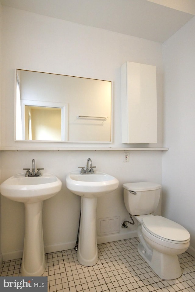 bathroom with tile patterned flooring and toilet