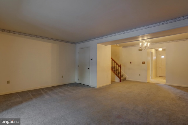 carpeted spare room with a notable chandelier