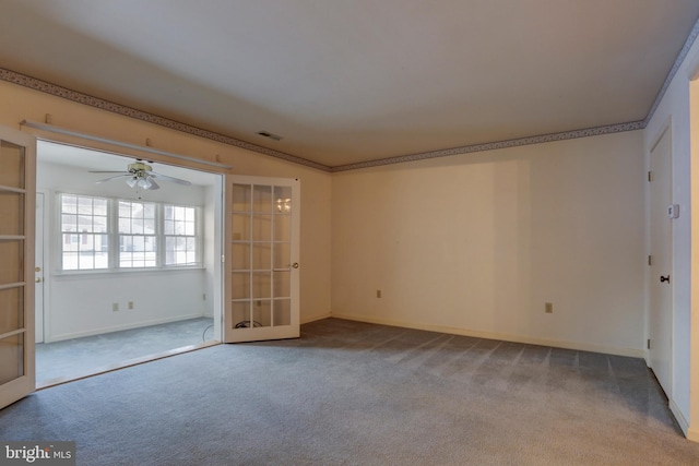 carpeted empty room with french doors and ceiling fan