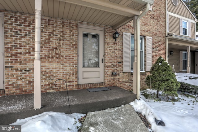 view of snow covered property entrance