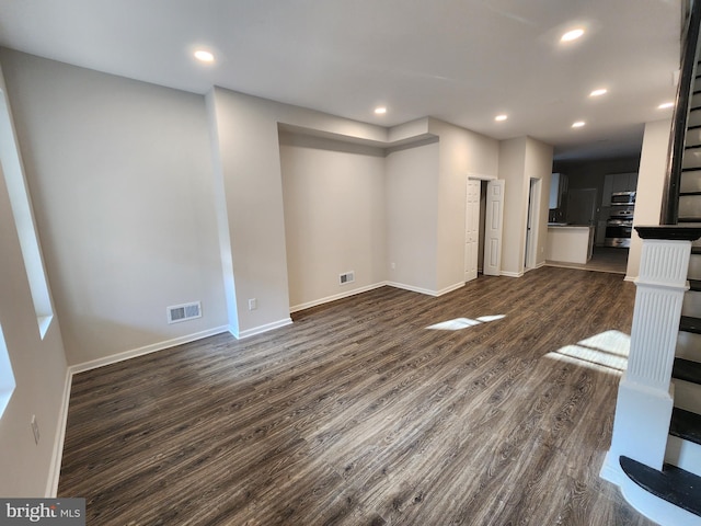 unfurnished living room featuring dark hardwood / wood-style flooring