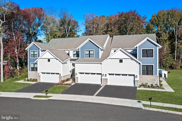 view of front of property featuring a garage and a front yard