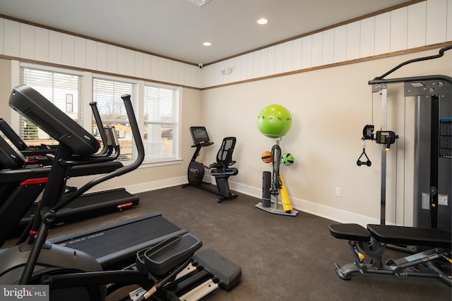 exercise room with crown molding and a healthy amount of sunlight