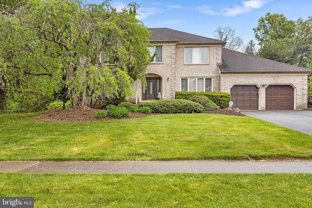 view of front of home with a garage and a front lawn