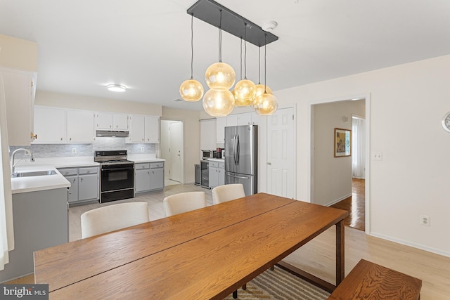 dining space featuring light hardwood / wood-style floors and sink