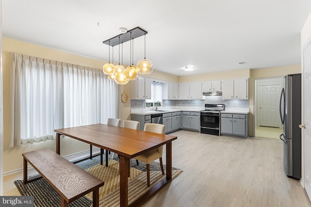 dining room featuring sink and light hardwood / wood-style floors