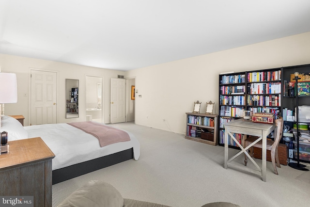 carpeted bedroom with ensuite bath