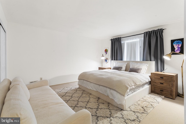 bedroom featuring light colored carpet