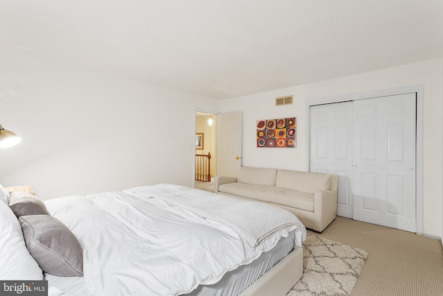 carpeted bedroom featuring a closet