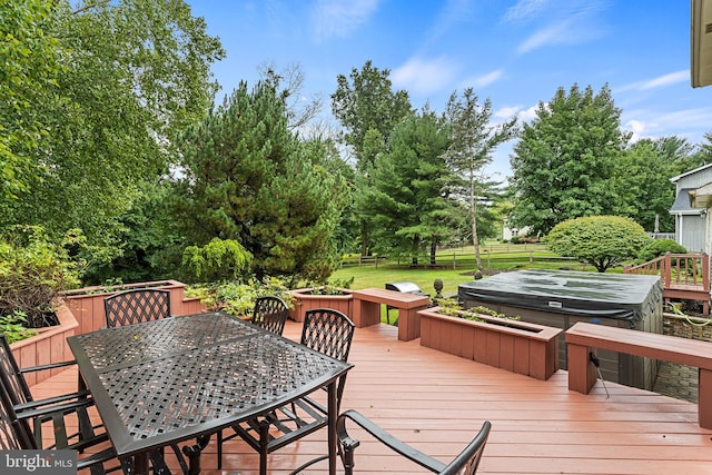 deck featuring a covered hot tub