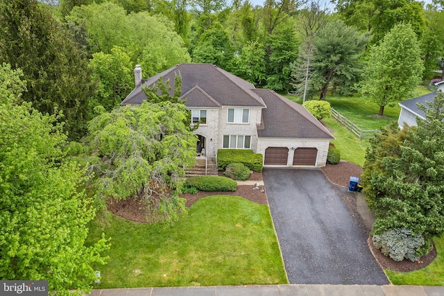 view of front of house featuring a garage and a front lawn