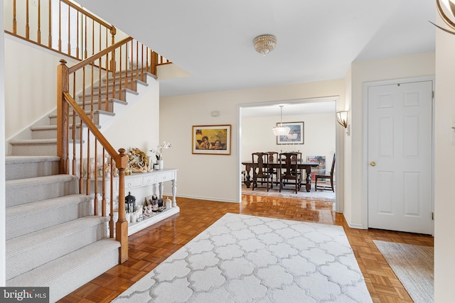 foyer entrance featuring parquet flooring