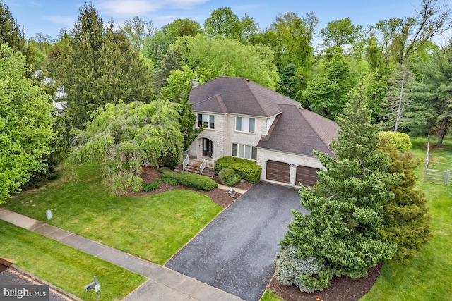 view of front of house featuring a garage and a front lawn