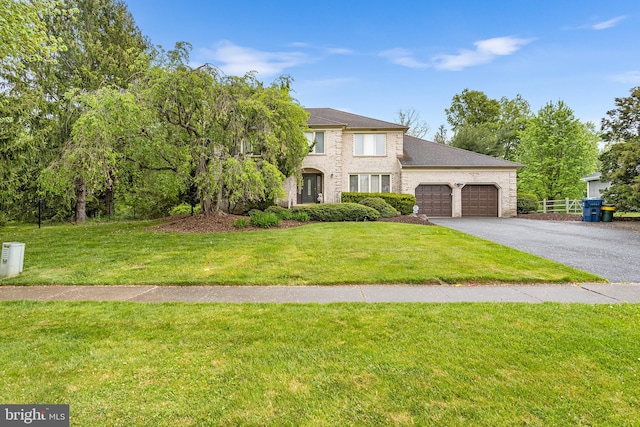 view of front of house with a garage and a front yard