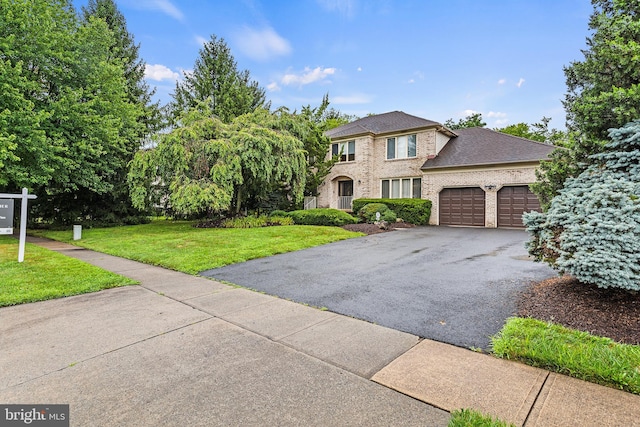 view of front of house featuring a garage and a front yard