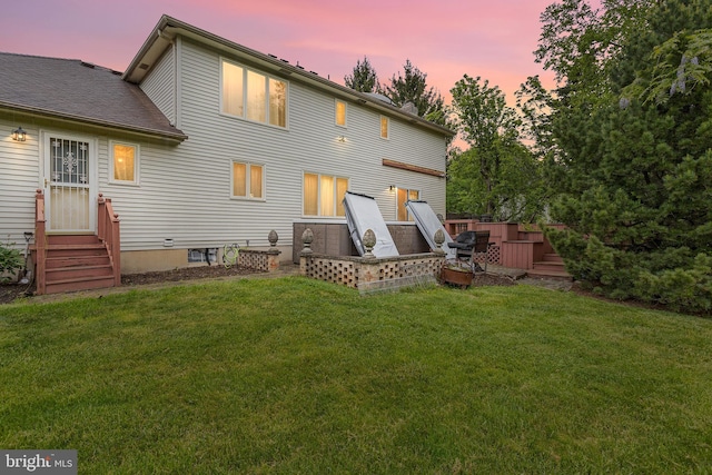 back house at dusk with a yard