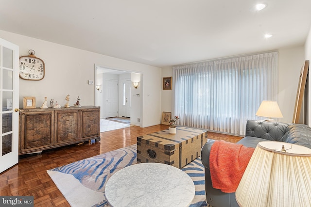 living room featuring dark parquet floors