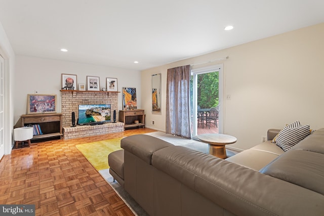 living room with parquet floors and a brick fireplace