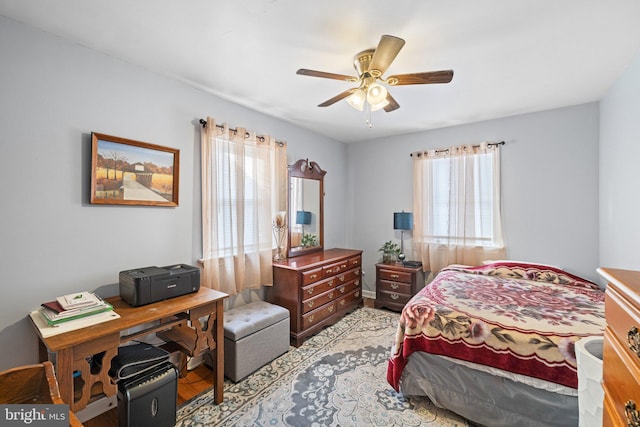 bedroom featuring multiple windows and ceiling fan