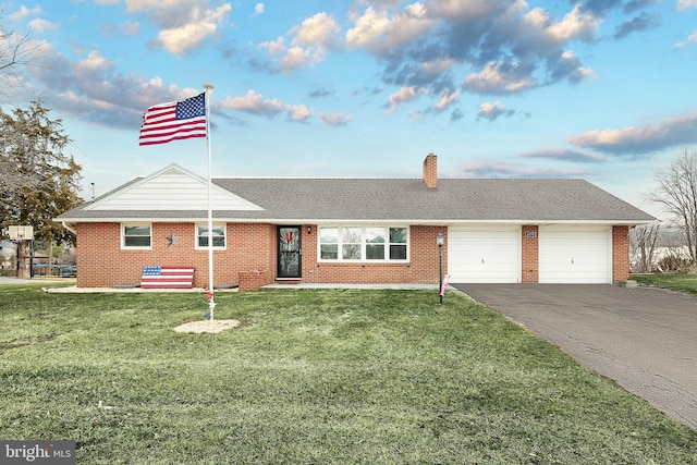 ranch-style house with a garage and a front lawn