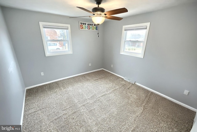 carpeted spare room with ceiling fan