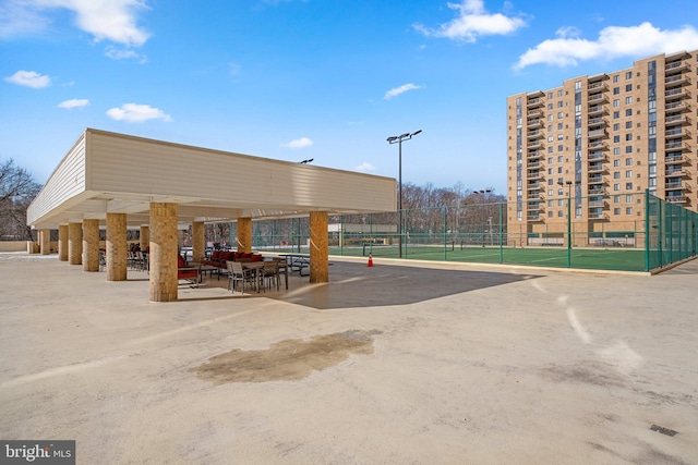 view of home's community with tennis court