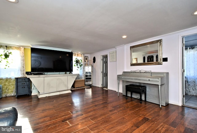 unfurnished living room featuring dark wood-type flooring and ornamental molding