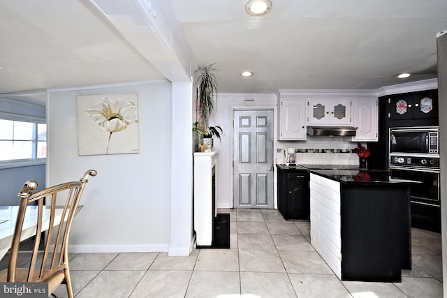 kitchen featuring light tile patterned flooring, white cabinets, decorative backsplash, a center island, and black appliances