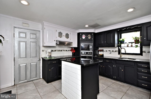 kitchen featuring sink, wall oven, white cabinets, a kitchen island, and built in microwave