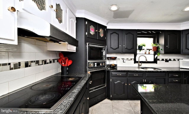 kitchen featuring light tile patterned flooring, tasteful backsplash, sink, black appliances, and crown molding