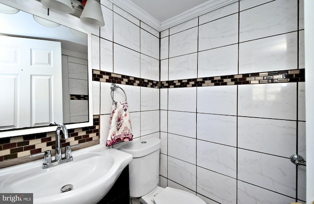 bathroom with tasteful backsplash, sink, tile walls, toilet, and crown molding