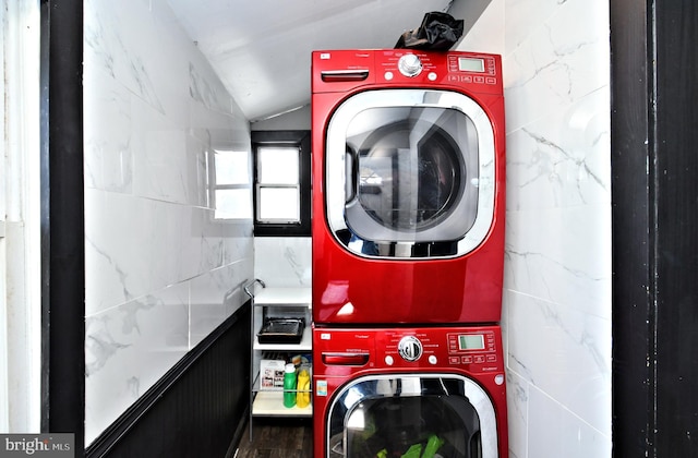 laundry room with stacked washer / drying machine